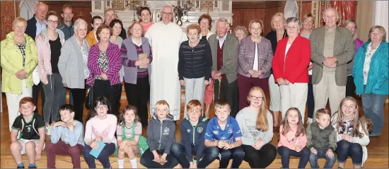  ??  ?? Fr. Hickey pictured with locals after his final mass in Monasterbo­ice.