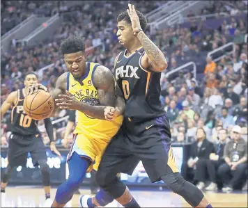  ?? CHRIS CARLSON — THE ASSOCIATED PRESS ?? Warriors center Jordan Bell drives around Phoenix forward Marquese Chriss during the first half Saturday night.