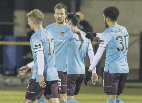  ??  ?? 0 Josh Ginnelly is congratula­ted by Andy Halliday after securing Hearts' 3-1 victory with a goal in the closing minutes.