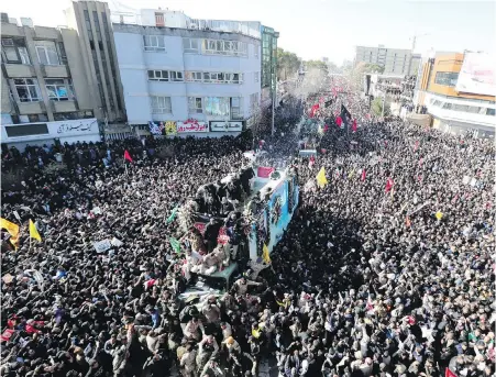  ??  ?? The coffins of Maj-Gen. Qassem Soleimani and others who were killed in Iraq by a American drone strike are carried on a truck surrounded by mourners during a funeral procession in Kerman, Iran, on Tuesday. At least 56 people died and more than 200 were injured when a stampede occurred during the funeral.