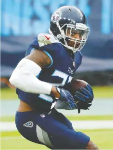 ?? FREDERICK BREEDON/ GETTY IMAGES ?? Running back Derrick Henry rushed for 212 yards and two touchdowns for the Tennessee Titans in a 42-36 overtime victory over the Houston Texans in Nashville on Sunday.