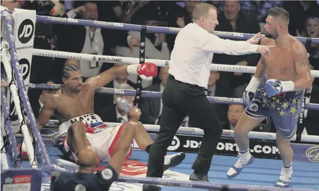  ??  ?? 0 Tony Bellew is sent to a neutral corner after knocking down David Haye on his way to a victory in five rounds at the O2 Arena in London on Saturday evening.