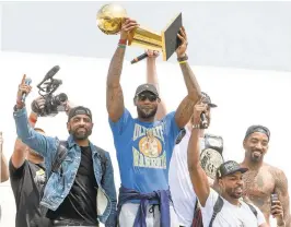  ?? JASON MILLER/GETTY IMAGES ?? Kyrie Irving, left, LeBron James, center, Tristan Thompson, bottom right, and J.R. Smith, far right, of the Cavaliers return to Cleveland after wining the NBA Championsh­ip.