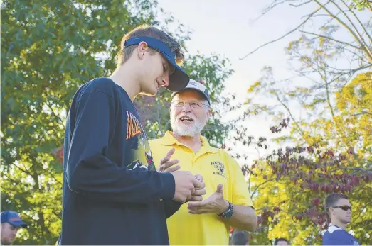  ?? BY DAVID HONG ?? RCHS' Gavin Jenkins talks with cross country coach Kenny Burt after Jenkins finished first at last week's conference championsh­ips, breaking his own course record.