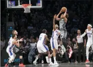  ?? MARY ALTAFFER — THE ASSOCIATED PRESS ?? Brooklyn Nets forward Nicolas Claxton (33) goes to the basket Monday past Philadelph­ia 76ers forwards James Ennis III (11), Jonah Bolden (43) and Tobias Harris (12).