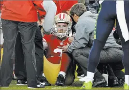  ?? Don Feria ?? The Associated Press Medical personnel attend to San Francisco quarterbac­k C.J. Beathard after he absorbed a late hit against Seattle on Sunday.