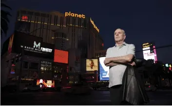  ?? K.M. CANNON — LAS VEGAS REVIEW-JOURNAL VIA AP ?? Reporter Jeff German poses with Planet Hollywood in the background on the Strip in Las Vegas on June 2.