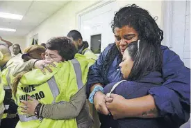  ??  ?? Rescue team members, from left, Candida Lozada, Stephanie Rivera, Mary Rodriguez and Zuly Ruiz embrace as they wait to assist Wednesday in the aftermath of Hurricane Maria in Humacao, Puerto Rico.