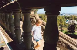  ?? Wally Skalij
Los Angeles Times ?? PHOEBE SASSO, 8, walks down a flight of stairs during a visit to Greystone Mansion, which could receive local landmark status under the new rules.