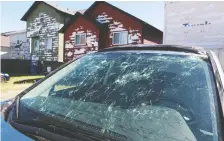  ?? GAVIN YOUNG ?? The aftermath of the intense hailstorm showed in damaged homes and cars in Saddle Ridge in northeast Calgary.