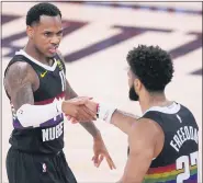  ?? MARK J. TERRILL — THE ASSOCIATED PRESS ?? Denver Nuggets’ Monte Morris, left, a Flint Beecher graduate, and Jamal Murray celebrate after Murray dunked during Denver’s win over the Los Angeles Lakers in Game 3 of the Western Conference Finals on Monday.