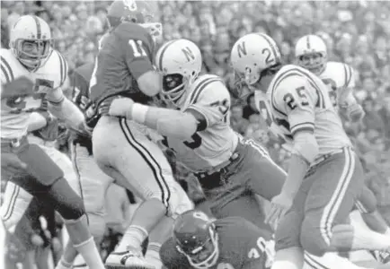  ?? LINCOLN JOURNAL STAR, FILE ?? Nebraska’s Rich Glover (79) brings down Oklahoma quarterbac­k Jack Mildren during the Game of the Century, on Nov. 25, 1971 in Norman. The Sooners and Cornhusker­s will meet again this Saturday in Norman.