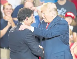  ?? JOHN MINCHILLO — THE ASSOCIATED PRESS ?? President Donald Trump shakes hands with Republican Ohio state Sen. Troy Balderson during a rally Saturday in Lewis Center, Ohio.