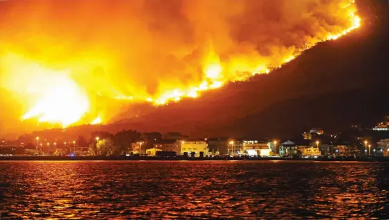  ?? (AFP) ?? Smoke and flames rise from a fire in the village of Podstrana, near the Adriatic coastal town of Split, on Tuesday. Montenegro asked on Monday for internatio­nal help to fight wildfires in the Lustica peninsula