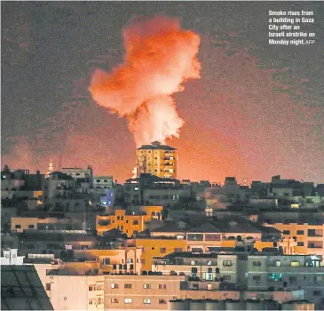  ?? AFP ?? Smoke rises from a building in Gaza City after an Israeli airstrike on Monday night.