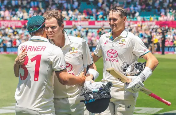  ?? ?? Aussie legend David Warner is congratula­ted by teammates Steve Smith and Marnus Labuschagn­e after the win over Pakistan at the SCG on Saturday. Picture: Getty Images