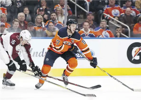  ?? IAN KUCERAK ?? Captain Connor McDavid scored the game-winner in overtime Thursday as the Edmonton Oilers defeated Nikita Zadorov, left, and the Colorado Avalanche 3-2 at Rogers Place despite the home team coughing up its second 2-0 lead this week.