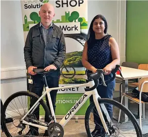  ?? ?? ●●Catering Manager Duncan O’Neil and Sustainabi­lity Manager Rajni Sisodiya with one of the Cycle Solutions e-bikes during Sustainabi­lity Day