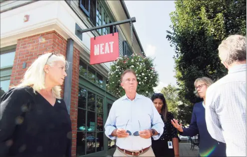  ?? Christian Abraham / Hearst Connecticu­t Media ?? Gov. Ned Lamont and First Selectman Jayme Stevenson, left, tour businesses damaged by flooding from Hurricane Ida in Darien on Sept. 10.