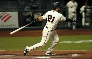  ?? LACHLAN CUNNINGHAM/GETTY IMAGES ?? Joey Bart of the Giants hits an RBI double against the Colorado Rockies at Oracle Park in San Francisco on Sept. 22, 2020.