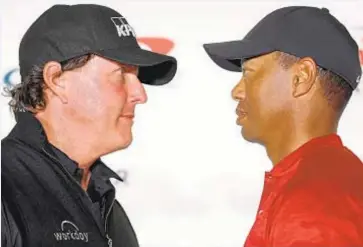  ?? PHOTO BY GETTY ?? Phil Mickelson and Tiger Woods face off during a press conference before The Match at Shadow Creek Golf Course in Las Vegas.