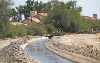  ?? ROSS D. FRANKLIN/ASSOCIATED PRESS ?? Water flows through a canal Saturday in Laveen, Ariz. Central Arizona has been booming — more people, more houses and more need for water. There’s also a long-term drought and less water to buy from the Central Arizona Project canal system.