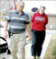  ?? File photo/NWA Democrat-Gazette ?? Cathy Lynn Torres, 43, is brought into the Bella Vista Police Department by Sgt. Clayton Roberts in March 2015. She was arrested on warrants charging her with capital murder, rape and battery in the first degree in the death of her 6-year-old son.
