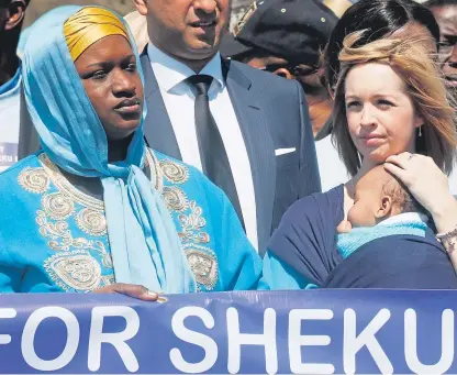  ?? Picture: PA. ?? Collette Bell, right, partner of Sheku Bayoh, carries their five-month-old son Isaac during the funeral procession in Kirkcaldy.