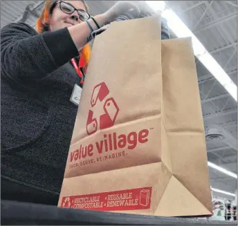  ?? SARA ERICSSON/SALTWIRE NETWORK ?? Value Village store manager Reg Chitty says his New Minas store branch has been using paper bags in lieu of plastic since August, and that the change has been a popular one with customers.