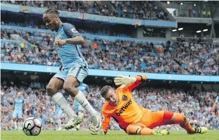  ?? — THE ASSOCIATED PRESS ?? Manchester City’s Raheem Sterling goes around West Ham United goalie Adrian before scoring his side’s third goal Sunday at Etihad Stadium in Manchester, England. Man City won 3-1.