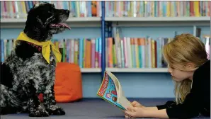  ??  ?? ALL EARS: Skye listens to May Coppola reading at Gylemuir Primary School