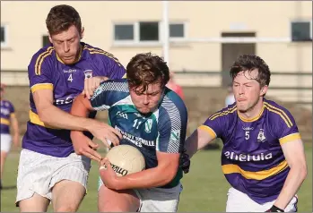  ??  ?? Jack O’Leary using his strength to get away from Peter Roche and Hughie Doyle of St. Patrick’s.