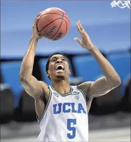  ?? Kyusung Gong Associated Press ?? UCLA guard Chris Smith, who has been sidelined since tearing an anterior cruciate ligament Dec. 31 versus Utah, is encouraged by the team’s growth on the court.