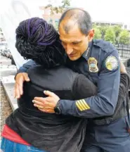  ?? STAFF PHOTO BY ROBIN RUDD ?? Chattanoog­a Police Chief Fred Fletcher hugs LaTesha Jones, the mother of crash victim Cor’Dayja Jones. Fletcher dropped by to offer support to the marchers.