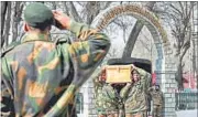  ?? PTI PHOTO ?? Jawans carry the body of Captain Pawan Kumar who lost his life in a gun battle with militants, in Srinagar on Sunday.