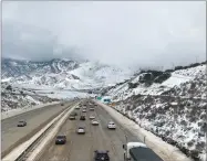  ??  ?? AP PHOTO In this Feb. 18, photo released by the California Highway Patrol Central Division shows traffic open on Interstate I-5 over Grapevine, Calif.