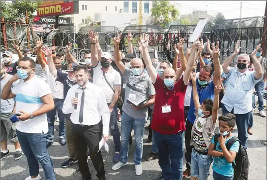  ??  ?? Dozens of Palestinia­ns flash the victory sign as they protest against their permanent settlement in Lebanon and demanding immigratio­n, near the US embassy in Aukar, northeast of Beirut, Lebanon. The financial crisis that the UN agency for Palestinia­n refugees is experienci­ng could lead to ceasing some of its activities in what would raise risks of instabilit­y in this volatile region,
the head of the agency said on Sept 16. (AP)