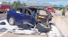  ?? ASSOCIATED PRESS ?? Emergency personnel work a the scene where a Tesla electric SUV crashed into a barrier on U.S. Highway 101 in Mountain View, Calif., on March 23. The vehicle was operating on autopilot.