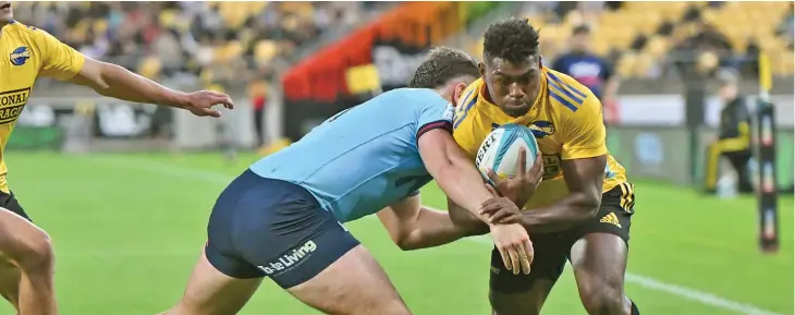  ?? Photo: Wide World of Sports ?? Fiji-born Hurricanes winger Kini Naholo on his way to score the first of his two tries against Waratahs at the Sky Stadium in Wellington on March 17, 2023.