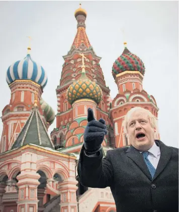 ?? Reports: Pages 4-5 ?? To Russia, with love: Boris Johnson, the Foreign Secretary, in front of St Basil’s Cathedral in Moscow yesterday. He attacked the Kremlin, saying it had unsuccessf­ully interfered in the EU referendum, and added he was winning a Cabinet battle over...