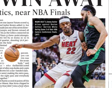  ?? (AFP) ?? MIAMI HEAT’S Jimmy Butler drives against Boston Celtics' Derrick White during Game 3 of their NBA Eastern Conference finals.