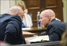  ?? ALYSSA POINTER / ALYSSA.POINTER@ AJC.COM ?? Defense attorneys Scott Johnston (left) and Larkin Lee confer among themselves Friday during the murder trial of their client, Franklin Gebhardt, at the Spalding County Courthouse in Griffin.