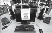  ?? TONY GUTIERREZ/AP ?? Signs on a bank of computers tell visitors that the machines are not working at the public library in Wilmer, Texas.