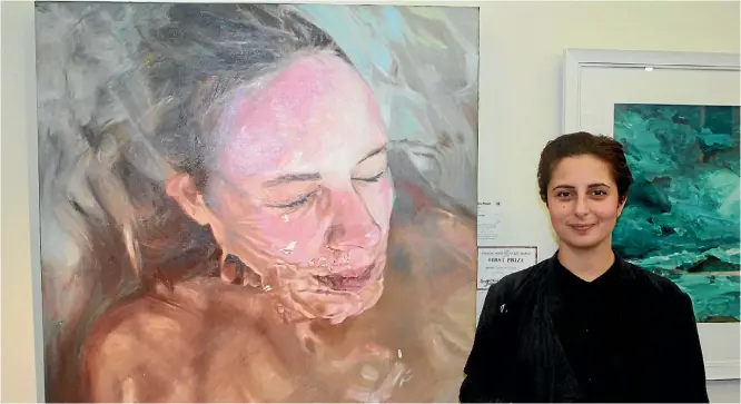  ?? KRIS BOULT ?? Nour Hassan with her painting, which won the Lysaght Watt Trust art award over all winner on May
3.