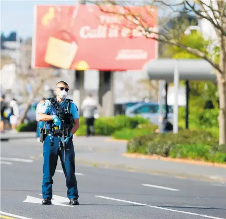  ?? Photo / Alex Burton ?? A police officer at the scene of Friday’s attack. Police say two victims of the attack remain in a critical but stable condition.