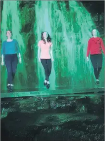  ??  ?? RIVERDANCE ... ARAGLIN STYLE: - The spectacula­r scene as Ciara Flanagan, Amie Landers and Faye O’Doherty knock out a set in front of the 3 Doons Waterfall, Araglin, lit as part of the St Patrick’s Day celebratio­ns in Araglin.