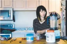  ??  ?? Chef Angela Huang makes a cranberry-turmeric-ginger smoothie in her kitchen in Boulder.