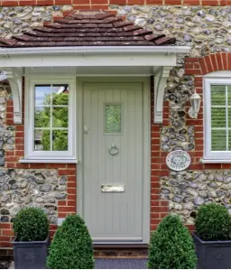  ??  ?? Below right: This composite unit from Thames Valley Windows is styled as a traditiona­l cottage entrance with modern chrome fittings