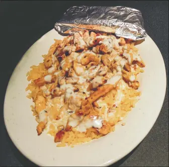  ?? DEREK OXFORD/NWA DEMOCRATGAZETTE ?? The Steven’s Special ( above), originated at Mexico Viejo and offers seasoned, grilled chicken on a bed of Spanish rice topped with white queso. It is served with freshly made tortillas.