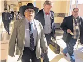  ?? MORGAN LEE/ASSOCIATED PRESS ?? Former New Mexico state Sen. Phil Griego, left, and his attorney Tom Clark, center, walk out of an arraignmen­t in Santa Fe District Court in Santa Fe in April 2016.